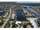 Aerial view of property situated on a waterfront lot with boat dock, showcasing coastal living at 1407 Waxwing Ct, Punta Gorda, FL 33950