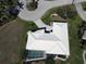 Overhead view of a well-maintained home featuring a screened pool, manicured lawn, and appealing roof design at 1407 Waxwing Ct, Punta Gorda, FL 33950