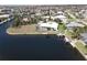 Beautiful aerial view of a waterfront home featuring a private boat dock, screened-in lanai, and lush landscaping at 1407 Waxwing Ct, Punta Gorda, FL 33950