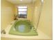 Large tub in bathroom featuring a showerhead and window at 1407 Waxwing Ct, Punta Gorda, FL 33950