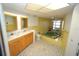 Well-lit bathroom with double vanity, bathtub, and decorative tile flooring at 1407 Waxwing Ct, Punta Gorda, FL 33950