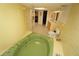 Bathroom featuring a sunken bathtub, shower, and double vanity at 1407 Waxwing Ct, Punta Gorda, FL 33950