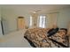 This primary bedroom features an ensuite and a sliding glass door that leads to an outdoor pool at 1407 Waxwing Ct, Punta Gorda, FL 33950