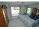 Bedroom featuring twin bed and large mirror, creating an inviting and functional space at 1407 Waxwing Ct, Punta Gorda, FL 33950