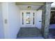 Inviting front entrance with decorative glass door, stone accents, and white brick facade at 1407 Waxwing Ct, Punta Gorda, FL 33950