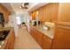Well-lit galley kitchen features granite countertops and light wood cabinetry at 1407 Waxwing Ct, Punta Gorda, FL 33950