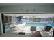 This lanai features a covered sitting area with a lovely view of the waterway and pool at 1407 Waxwing Ct, Punta Gorda, FL 33950