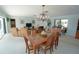 Spacious living area with dining table, chandelier, and comfortable seating arrangement at 1407 Waxwing Ct, Punta Gorda, FL 33950