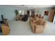 Bright living area featuring multiple seating areas and access to the kitchen at 1407 Waxwing Ct, Punta Gorda, FL 33950