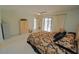 Bright bedroom with ceiling fan, closet, ensuite bathroom and access to pool at 1407 Waxwing Ct, Punta Gorda, FL 33950