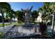 Unique wooden sculpture surrounded by tropical trees, enhancing the local art scene and community at 1407 Waxwing Ct, Punta Gorda, FL 33950