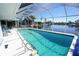 Inviting screened pool with tranquil waterfront views, perfect for relaxing and entertaining guests at 1407 Waxwing Ct, Punta Gorda, FL 33950
