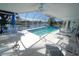 This covered pool area features a covered seating area with a beautiful view of the waterway at 1407 Waxwing Ct, Punta Gorda, FL 33950