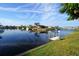 Scenic waterfront view with calm water, docks, boats, and lush landscaping in a tropical setting at 1407 Waxwing Ct, Punta Gorda, FL 33950