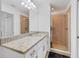 Bright bathroom featuring a granite countertop vanity and glass shower at 14071 Heritage Landing Blvd # 325, Punta Gorda, FL 33955