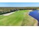 High angle image showing a well-maintained golf course alongside a tranquil lake at 14071 Heritage Landing Blvd # 325, Punta Gorda, FL 33955