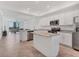 Open kitchen featuring stainless steel appliances, granite countertops, and a convenient center island at 14071 Heritage Landing Blvd # 325, Punta Gorda, FL 33955