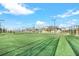 Daytime view of community tennis courts and clubhouse with beautiful blue skies at 14071 Heritage Landing Blvd # 325, Punta Gorda, FL 33955