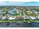 Aerial view of waterfront home with boat dock, canal access, and neighborhood setting at 1492 Aqui Esta Dr, Punta Gorda, FL 33950