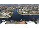 Aerial view showcasing waterfront homes along the canal, many with private docks, boat lifts, and screened-in pools at 1492 Aqui Esta Dr, Punta Gorda, FL 33950