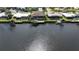 Aerial view showing the neighborhood with waterfront homes, boat docks and a boat lift at 1492 Aqui Esta Dr, Punta Gorda, FL 33950