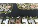 Stunning aerial view of waterfront homes on a canal, offering boat docks and beautiful landscaping at 1492 Aqui Esta Dr, Punta Gorda, FL 33950