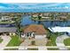 Waterfront property featuring lush landscaping, a boat dock, and serene water views at 1492 Aqui Esta Dr, Punta Gorda, FL 33950