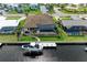 Aerial view of home with boat dock, backyard and beautiful waterfront access at 1492 Aqui Esta Dr, Punta Gorda, FL 33950