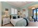 Inviting bedroom with a comfortable bed, soft colors, and plantation shutters at 1492 Aqui Esta Dr, Punta Gorda, FL 33950