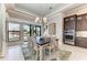 Spacious dining room with a large window showcasing waterfront views and updated kitchen at 1492 Aqui Esta Dr, Punta Gorda, FL 33950