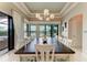 Bright dining room features stylish lighting and a view of the lanai and waterfront at 1492 Aqui Esta Dr, Punta Gorda, FL 33950