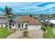 Beautiful waterfront home featuring manicured landscaping, brick driveway, and tile roof at 1492 Aqui Esta Dr, Punta Gorda, FL 33950