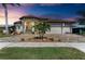 Elegant home featuring a paver driveway, tile roof, manicured landscaping, and a three-car garage at 1492 Aqui Esta Dr, Punta Gorda, FL 33950