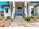 Elegant home entrance featuring stone steps, manicured landscaping, and a welcoming front door at 1492 Aqui Esta Dr, Punta Gorda, FL 33950