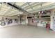 Spacious garage with organized storage and a durable, finished floor at 1492 Aqui Esta Dr, Punta Gorda, FL 33950