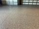 Close-up of durable epoxy flooring in a garage, providing a clean and modern look at 1492 Aqui Esta Dr, Punta Gorda, FL 33950