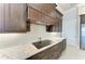 Kitchen cooktop with custom range hood, granite countertops and tile backsplash at 1492 Aqui Esta Dr, Punta Gorda, FL 33950