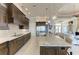 Spacious kitchen features custom cabinets, stainless steel appliances, granite countertops, and tile flooring at 1492 Aqui Esta Dr, Punta Gorda, FL 33950