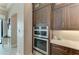 Gourmet stainless steel oven and microwave installed in custom cabinets with granite countertops at 1492 Aqui Esta Dr, Punta Gorda, FL 33950