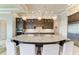 Open kitchen with a large island, granite countertops, custom cabinets, stainless steel appliances, and pendant lighting at 1492 Aqui Esta Dr, Punta Gorda, FL 33950