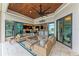 Spacious screened lanai with ample seating, tile floors, and dark wood ceiling at 1492 Aqui Esta Dr, Punta Gorda, FL 33950