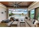 Comfortable screened lanai with waterfront views, fan, and stylish decor at 1492 Aqui Esta Dr, Punta Gorda, FL 33950
