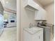 Modern laundry room with ample counter space and sleek appliances at 1492 Aqui Esta Dr, Punta Gorda, FL 33950