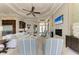 Bright living room featuring a ceiling fan, modern furniture, and a cozy fireplace with a television screen above at 1492 Aqui Esta Dr, Punta Gorda, FL 33950