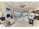 Spacious living room with a fireplace, tv, and open floorplan overlooking the water at 1492 Aqui Esta Dr, Punta Gorda, FL 33950