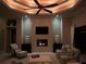 Living room at night with fireplace featuring decorative tile, comfortable seating and accent lighting at 1492 Aqui Esta Dr, Punta Gorda, FL 33950