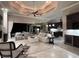 Expansive living room open to the kitchen boasts a coffered ceiling and seamless indoor-outdoor flow at 1492 Aqui Esta Dr, Punta Gorda, FL 33950
