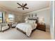 Relaxing main bedroom retreat featuring a ceiling fan, carpet floors, and plenty of natural light at 1492 Aqui Esta Dr, Punta Gorda, FL 33950