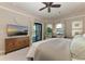 Spacious primary bedroom with a plush bed, a TV, and access to a private lanai at 1492 Aqui Esta Dr, Punta Gorda, FL 33950