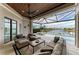 Screened-in outdoor living space featuring comfortable seating overlooking a pool and canal at 1492 Aqui Esta Dr, Punta Gorda, FL 33950